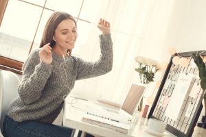 Young woman freelancer indoors home office concept winter atmosphere sitting listening music