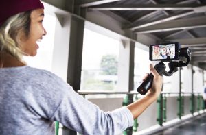 girl holding phone camera