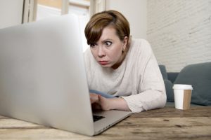 young attractive and busy woman at home sofa couch doing some laptop computer work in stress looking worried in entrepreneur lifestyle