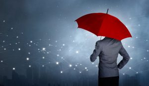 Businessman standing while holding and red umbrella over the net