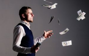 Richness and wealth concept. entrepreneur on arrogant face wasting money.