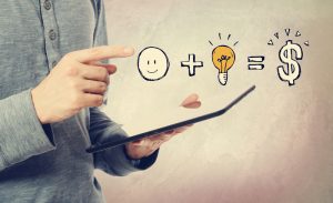 Good idea equals money with man holding a tablet