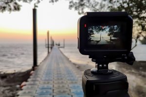 Camera mounted on a tripod photograph the pier and sunrise, Focu