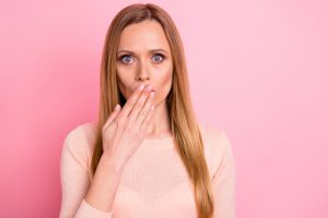 Close up photo of amazed person share secret novelty close cover face isolated over pink background