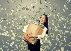 excited young woman with money