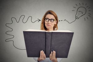 Woman reading a huge book has a good idea