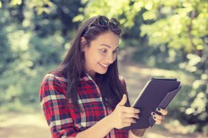 woman excited looking at touch pad pc