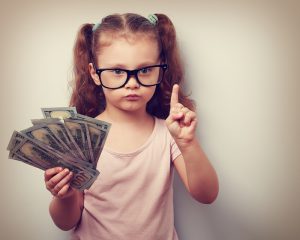Cute kid girl holding dollars and have an idea how earning much