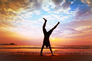 freedom and creativity, man jumping on the beach