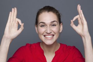 ecstatic young woman gesturing to express winning success