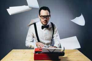 man writing on typewriter