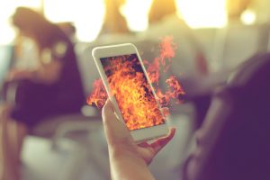 Woman's hand Using a Smart Phone with flame fire as hot, hot new