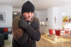 Portrait of sick man shivering from cold