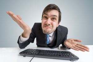 Confused frustrated and unsure man is working with computer.