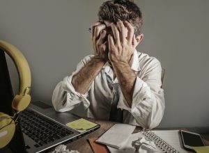 man at messy desk