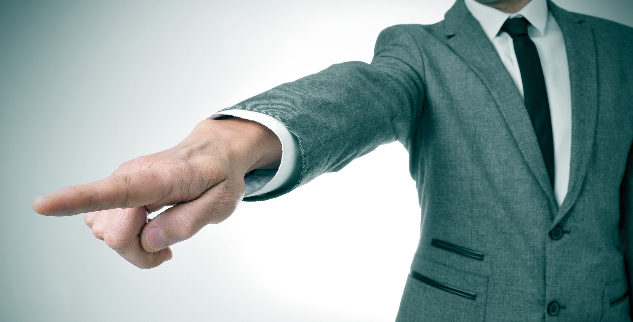 man in suit pointing with finger showing the way out dreamstime_m